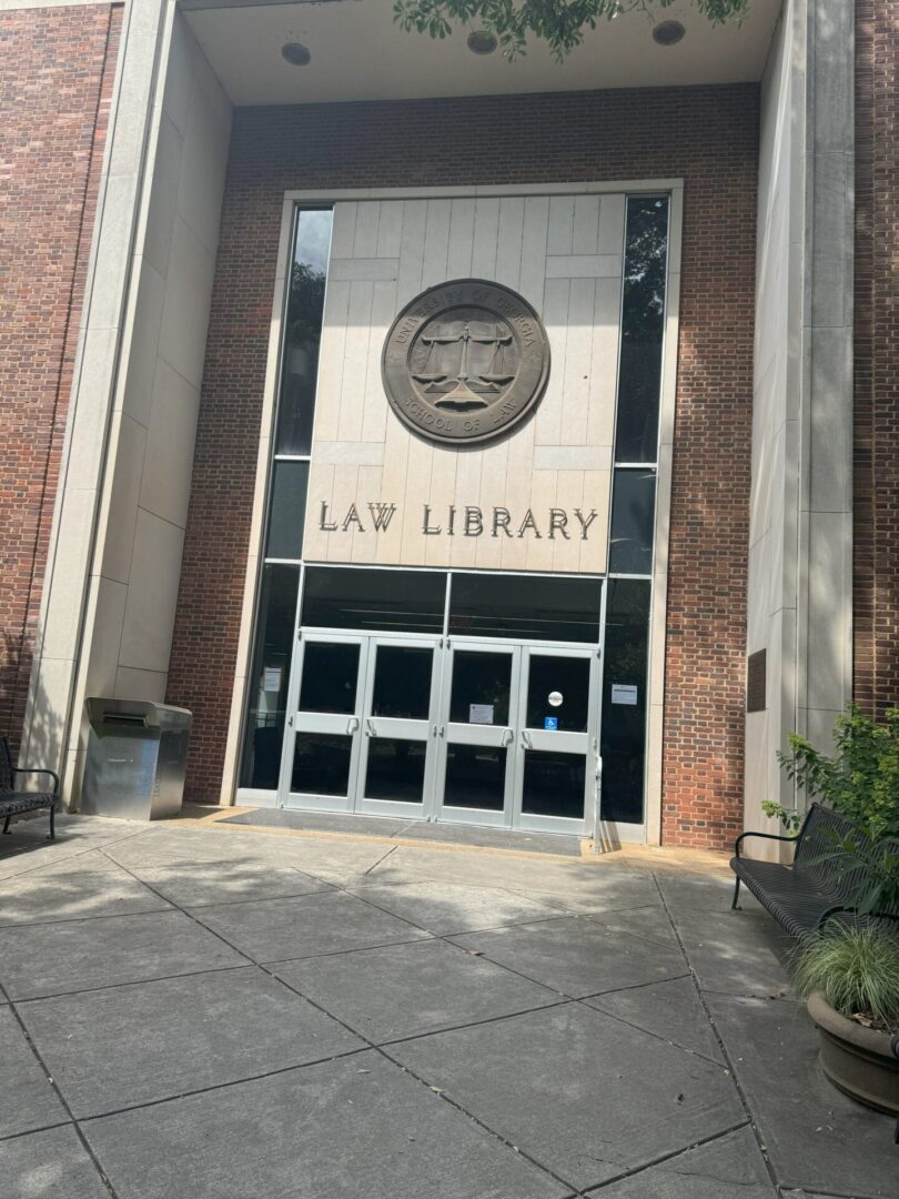 Entrance of a law library with glass doors and brick walls.